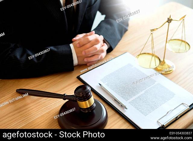 tribunal Attorney lawyer working with documents and wooden gavel on tabel in courtroom. justice advice and law judge legislation concept