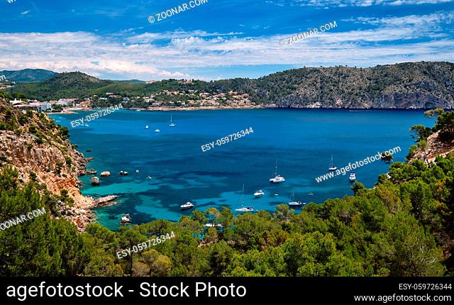 Above view turquoise bay full of moored luxury yachts motorboats in the Mediterranean Sea, picturesque Cala Blanca Andratx