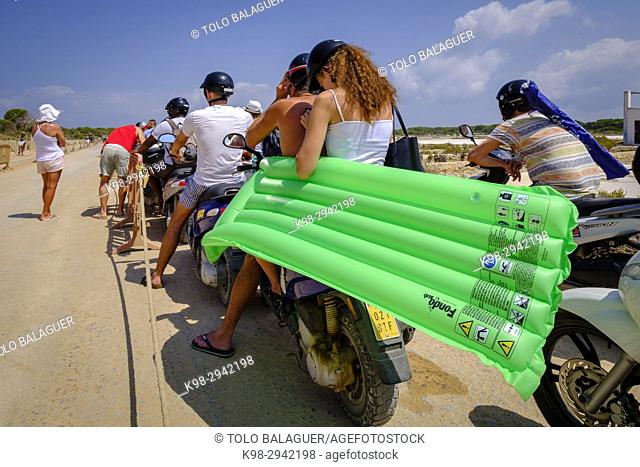 Italian tourists in a motorcycle queue at the entrance of the park, camino de Sa Guia, Parque natural de ses Salines de Ibiza y Formentera, Formentera