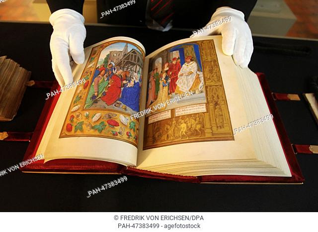 A man leafs through the pages of the facsimile of 'Brevarium Grimani' at the exhibition Princes of the Church, Art Patrons, Codices at Martinus Library in Mainz