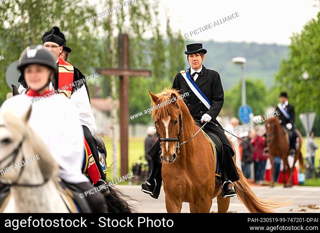 19 May 2023, Baden-Württemberg, Weingarten: A woman rides in the procession. The Blood Ride is Europe's largest equestrian procession in honor of the Holy Blood...