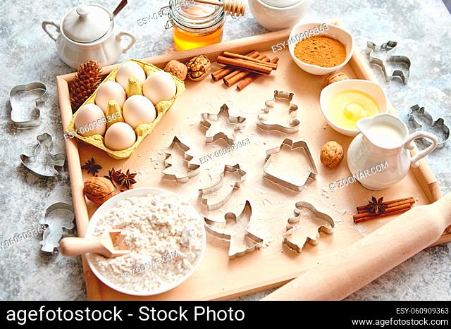 Delicious fresh and healthy ingredients for Christmas gingerbread. Placed on a wooden pastry board. View from above