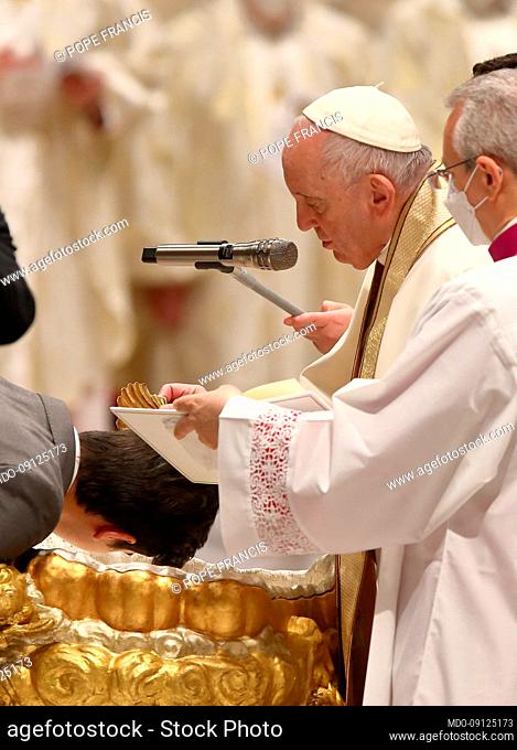 Pope Francis gives the sacrament of baptism to neophytes during the Easter Vigil celebrated by Cardinal Giovanni Battista Re, Dean of the College of Cardinals
