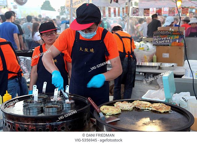 CANADA, MARKHAM, 24.07.2015, A food vendor preparing Okonomiyaki (Japanese pancakes containing a variety of ingredients) during an all-night Chinese market held...