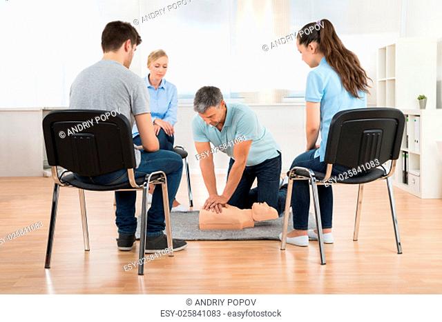 Male Instructor Teaching First Aid Cpr Technique To His Students