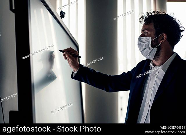 Businessman with protective face mask working in office