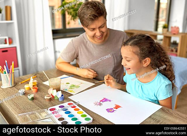 happy father with little daughter drawing at home