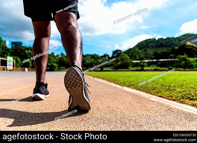 Asian young athlete sport runner black man wear feet active ready to running training at the outdoor on the treadmill line road for a step forward