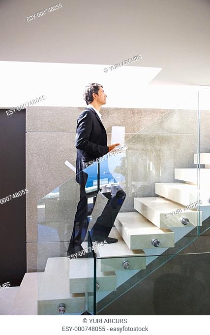 Portrait of a business man walking up the stairs