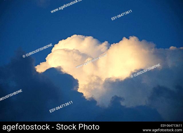 White and dark heart shaped heavy clouds in the blue background