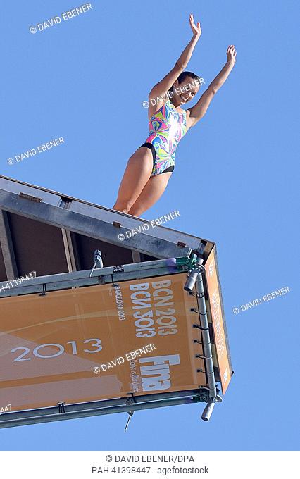 Bronze medalist Anna Bader of Germany waves to the spectators before a jump during the women's 18m high diving final of the 15th FINA Swimming World...