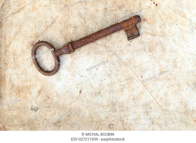Detail of the rusty key on old parchment