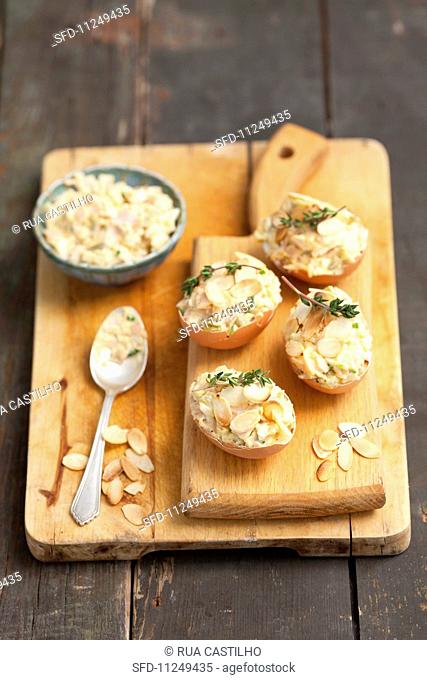 Egg salad with slivered almonds served in eggshells