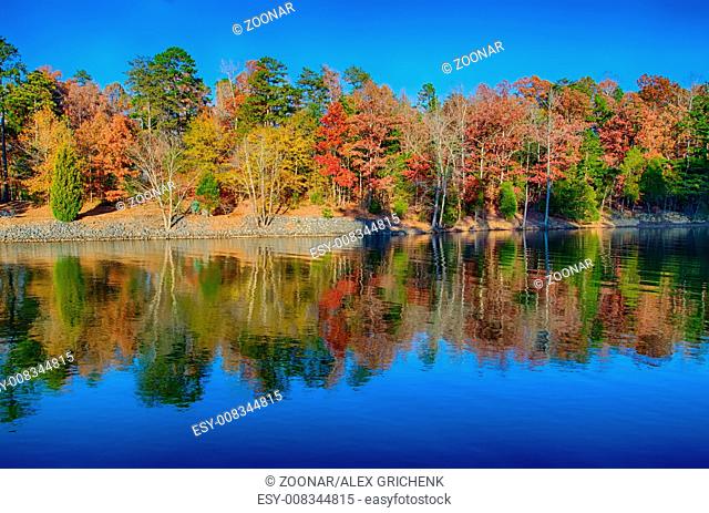 Autumn Landscape. Park in Autumn. The bright colors of autumn in the park by the lake