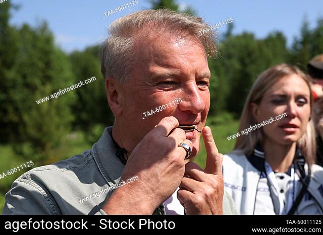 RUSSIA, ALTAI REPUBLIC - JUNE 22, 2023: Sberbank CEO Herman Gref plays the cheler komus (Altai mouth harp) during a guided eco trail tourin Manzherok resort...