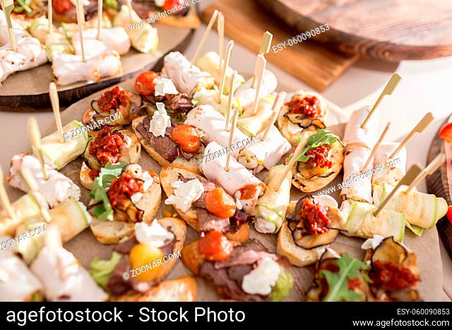 Assorted canape with cheese, meat, rolls, bakery and vegetables. Food to accompany the drinks. the buffet at the Banquet