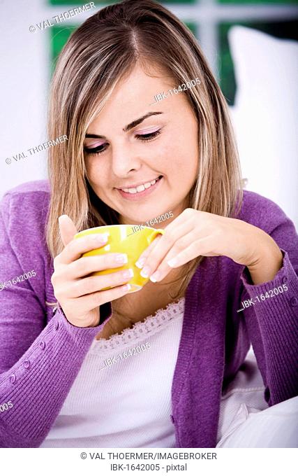 Young Woman with a mug in the living room