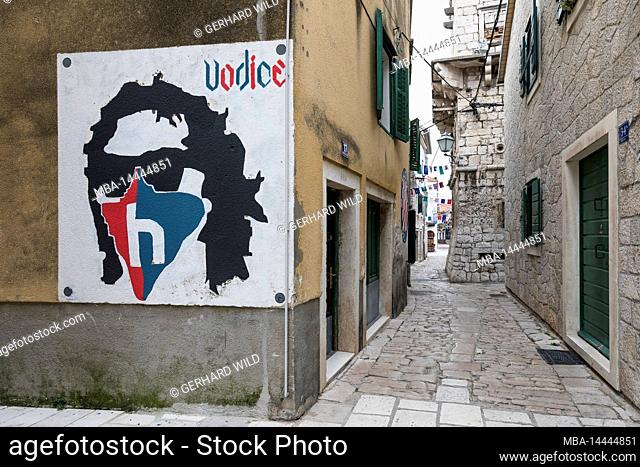 Wall painting and narrow alley in small town Vodice, Sibenik-Knin County, Central Dalmatia, Croatia, Europe