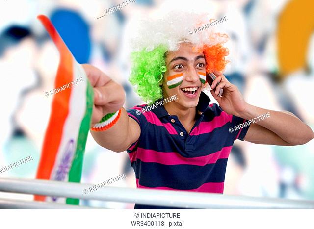 Boy talking on a phone and cheering