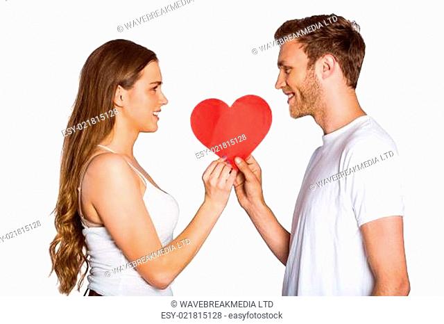 Romantic young couple holding heart