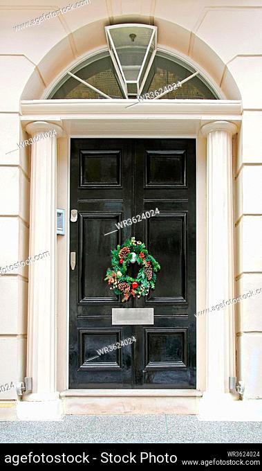 Luxurious front door with conifer Christmas wreath