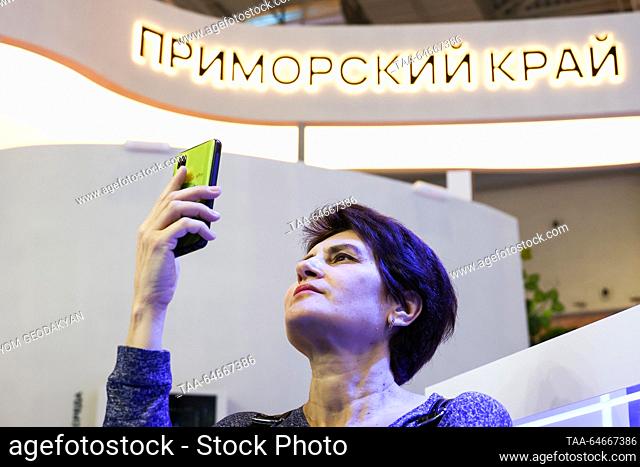 RUSSIA, MOSCOW - NOVEMBER 11, 2023: A woman with a mobile phone is seen at the opening of Kamchatka Region Day at the Russia Expo international exhibition and...