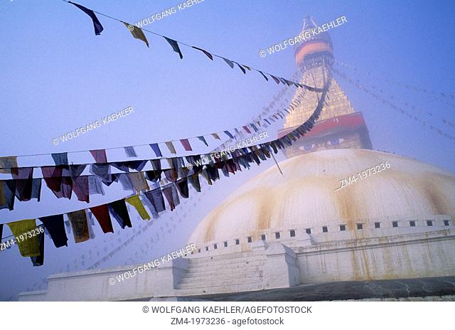 NEPAL, KATHMANDU, BOUDHNATH, TIBETAN STUPA (TEMPLE) IN FOG, PRAYER FLAGS