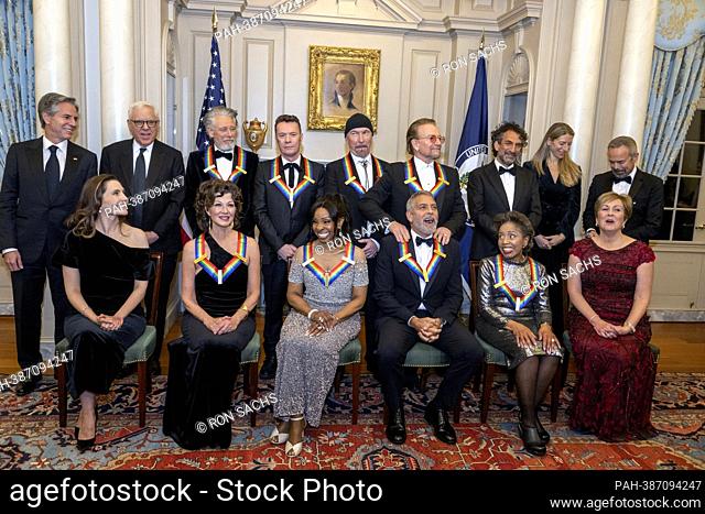 2022 Kennedy Center Honoree George Clooney, bottom third from right, reacts as he is given a shoulder rub from fellow 2022 Honoree Bono as they pose for a group...
