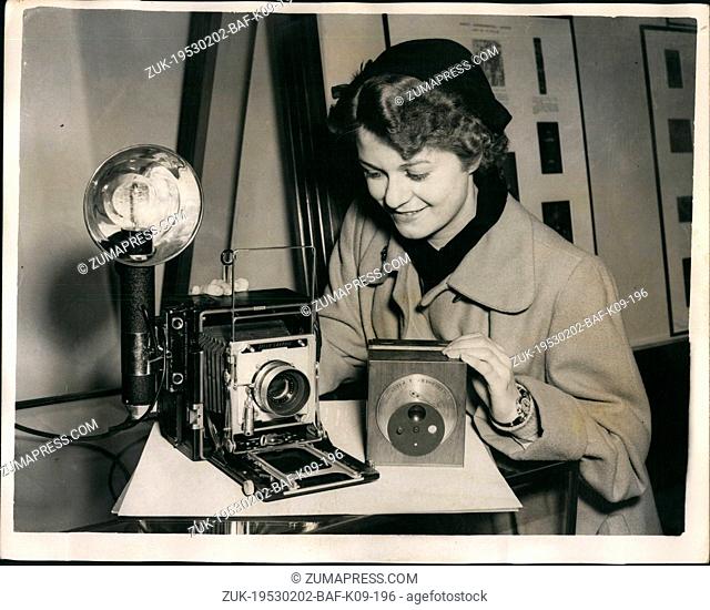 Feb. 02, 1953 - R.P.S. Centenary Exhibition in London. Ancient Andmodern: Picture shows: Miss Betty Sheppard of Leicester- makes a comparison of a Daguerreotype...