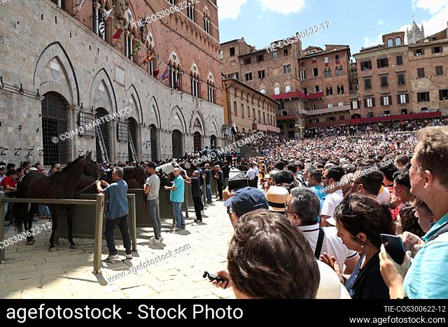 A large crowd watches the race. Palio Siena, Tuscany, Italy 29 June 2022