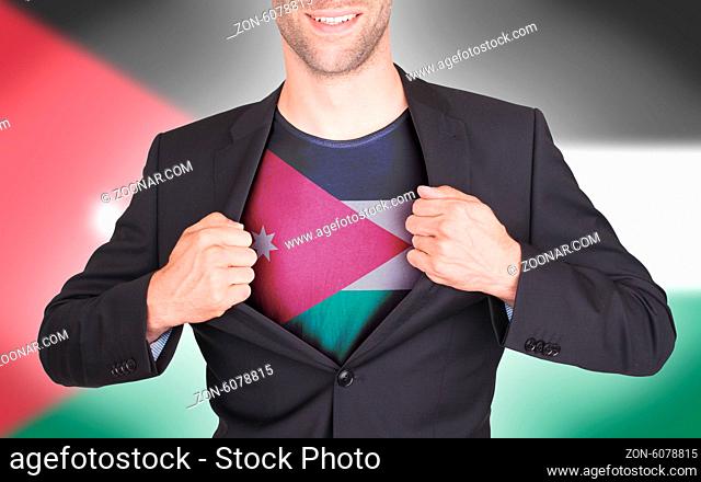 Businessman opening suit to reveal shirt with flag, Jordan