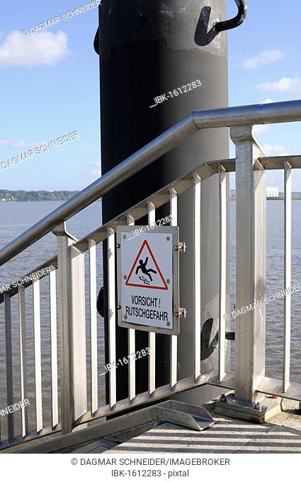 A sign Vorsicht Rutschgefahr, German for caution, slip hazard at the Hamburg harbour, Germany, Europe