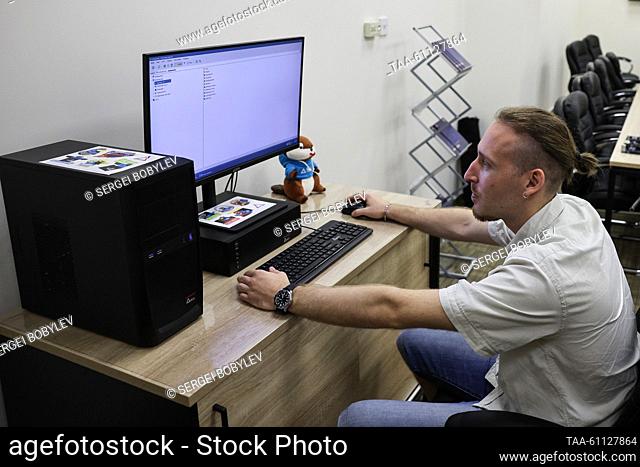 RUSSIA, MOSCOW - AUGUST 17, 2023: A man at the Voron and Bober personal computers made by the Russian IT company Delta Computers. Sergei Bobylev/TASS