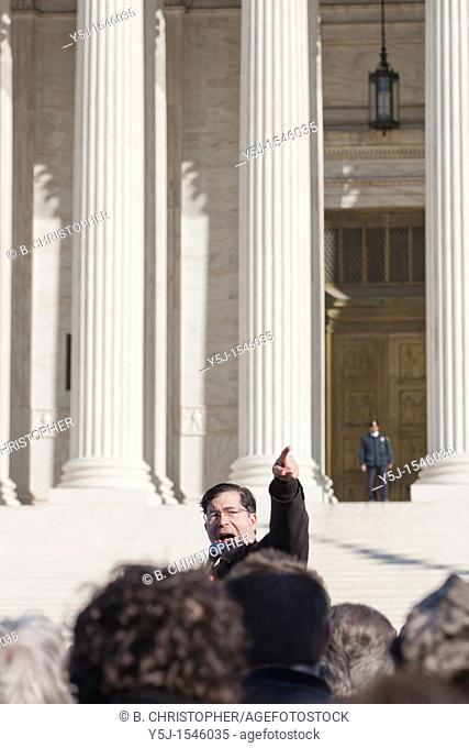 A Pro-Life supporter speaks to supporters in front of the Supreme Court