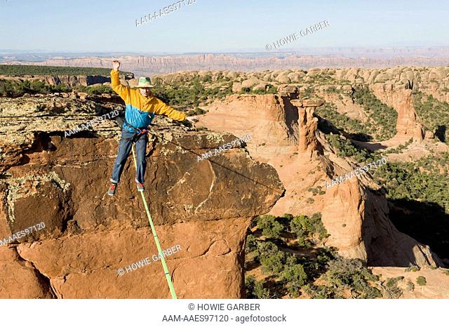 Larry Harpe highlining between Navaho Sandstone Towers on BLM land near Moab, Utah