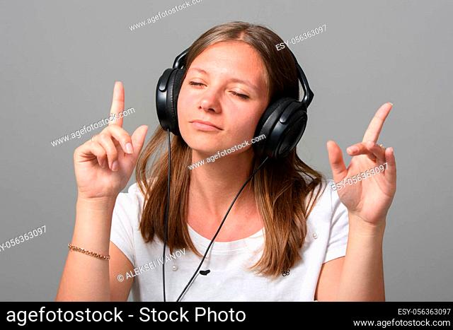 Portrait of a girl listening to music on headphones