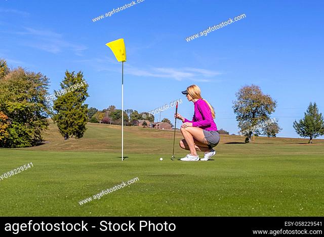 A beautiful blonde model enjoying a round of golf on a sunny day