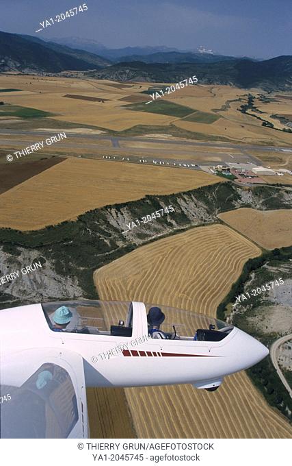 Aerial view of glider plane Twin Astir flying over aerodrome of Santa Cilia de Jaca, Aragon, Spain