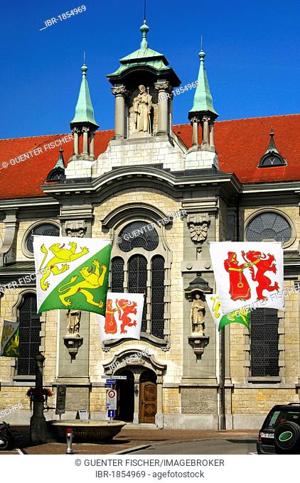Flags with the coat of arms of the canton of Thurgau and the Frauenfeld village in front of the Catholic church of St Nikolaus, Frauenfeld, Canton Thurgau