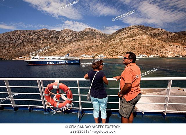 Tourists looking from the deck at the passing ferry, Sifnos, Cyclades Islands, Greek Islands, Greece, Europe