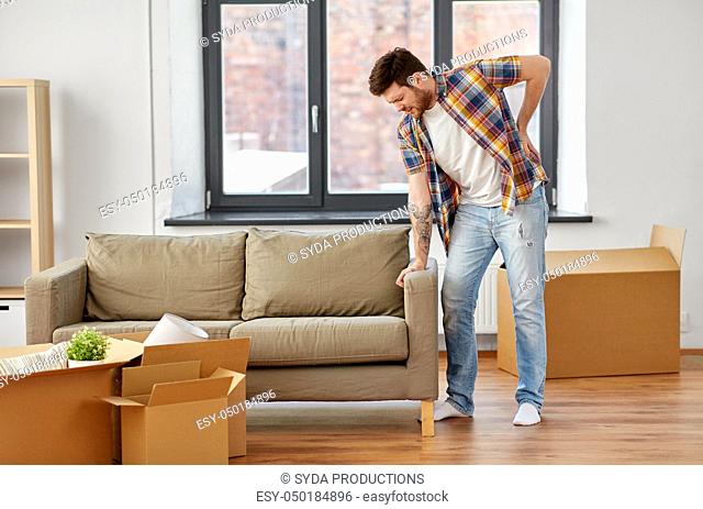 man having back ache moving to new home