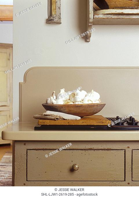KITCHENS - Detail shot of almost hidden cooling range with backsplash. Custom designed cream colored cabinetry. Distressed finish