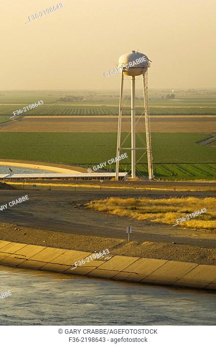California Aqueduct and water storage tower at sunset in the Central Valley, near Los Banos, Merced County, California