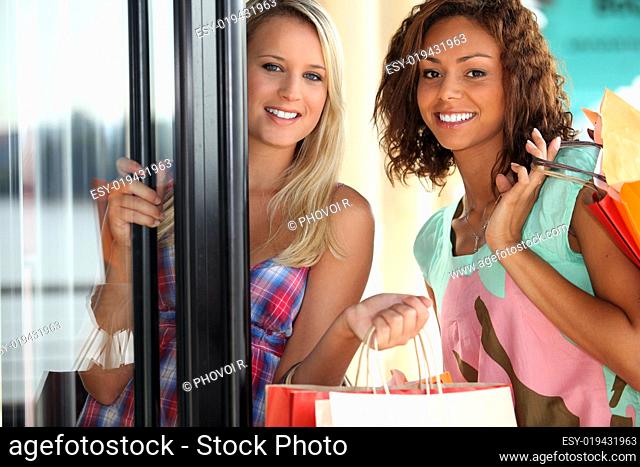 portrait of two girls with shopping bags