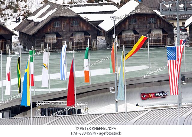 The four-person Bob with Simone Bertazzo, Francesco Coasta, Giovanni Mulassano and Giuseppe Gibolisco from Italy on the echo-curve lined with flags in Schoenau...