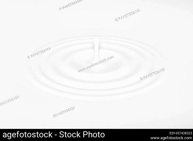 Drop falling on milk, cream dairy product, lotion or paint, creating round ripples with a swirl. Vector illustration