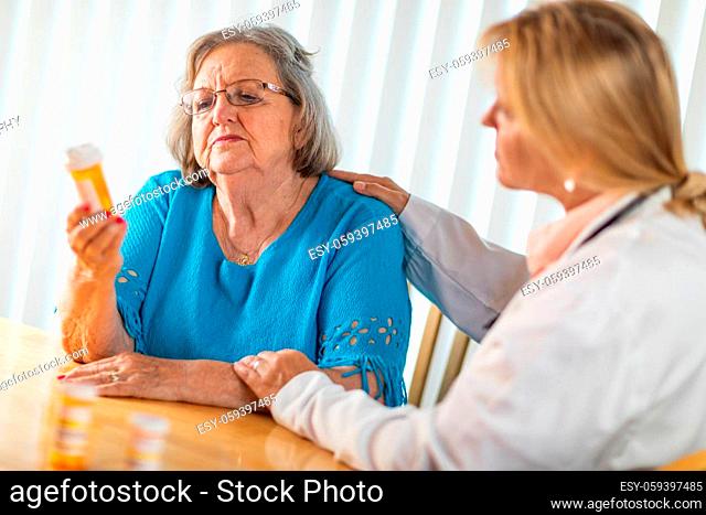 Female Doctor Talking with Senior Adult Woman About Medicine Prescription