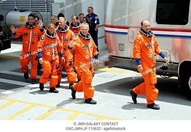 After suiting up, the STS-127 crew members exit the Operations and Checkout Building to board the Astrovan, which will take them to launch pad 39A for the...