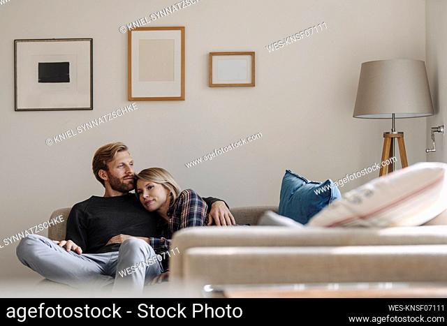 Relaxed couple on sofa at home