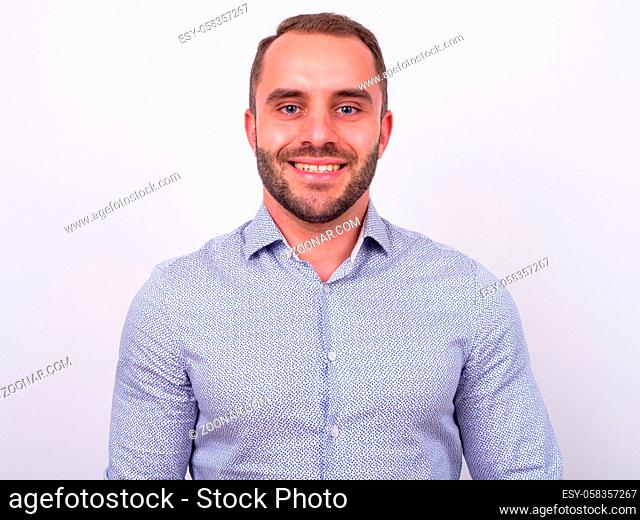 Studio shot of muscular bearded businessman against white background
